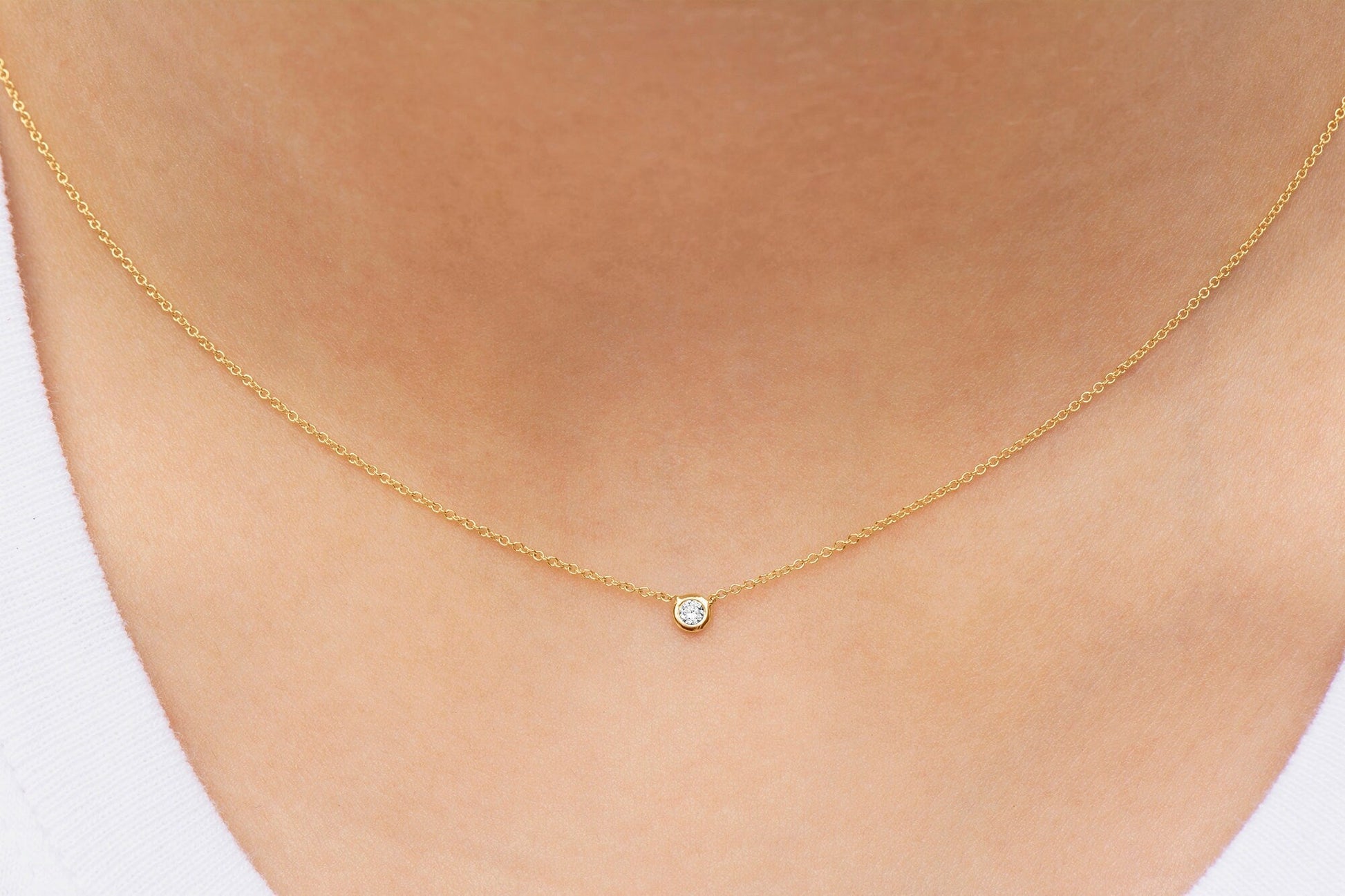 Women Wearing a Round Brilliant Cut Bezel Set Diamond Pendant of .05 carat